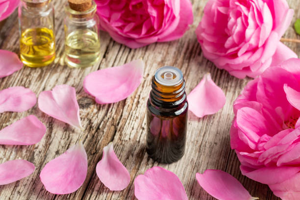 istock A bottle of rose essential oil with fresh roses 968475764