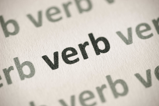 word verb printed on white paper macro