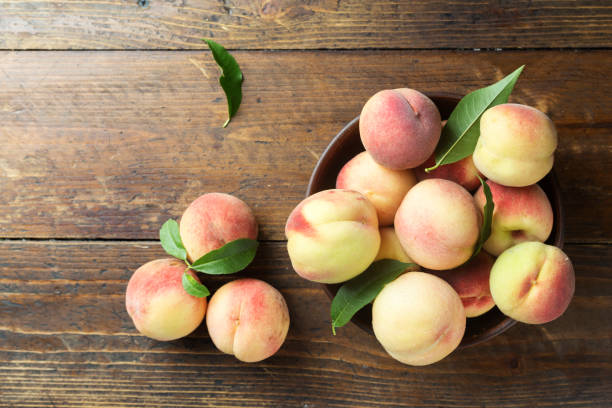 istock ripe peaches on a wooden background 968476310