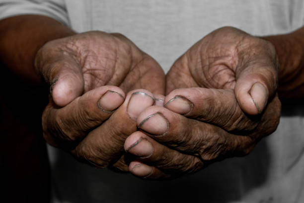 istock Hands poor poverty elder man begging you for help. Concept hunger people or poverty. Selective focus. Poverty in retirement. 968480008