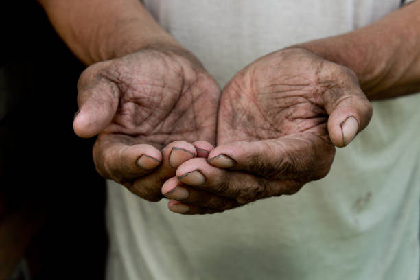 istock The poor old man's hands beg you for help. The concept of hunger or poverty. Selective focus. Poverty in retirement. Alms 968480042