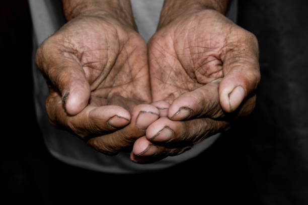 istock Hands poor poverty elder man begging you for help. Concept hunger people or poverty. Selective focus. Poverty in retirement. 968480082