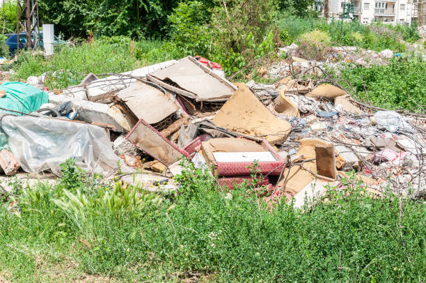 istock Garbage dump on the grass near the forest ecological disaster concept polluting nature and city park with litter and junk 968488640