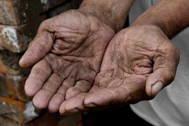 istock Hands poor poverty elder man begging you for help. Concept hunger people or poverty. Selective focus. Poverty in retirement. 968488654