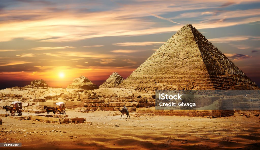 Pyramid in desert Bedouin on camel near pyramids in desert Egypt Stock Photo