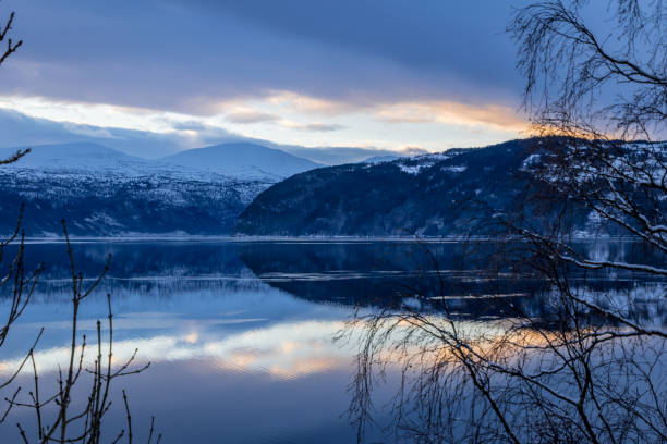 istock Reflection of sunset and mountains in lake 968493746