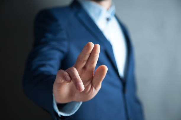 istock male is standing and shows outstretched hand with open palm 968498340