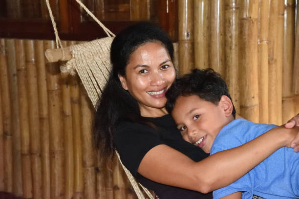 istock Mother and son relax on a hammock in the Philippines 968498650