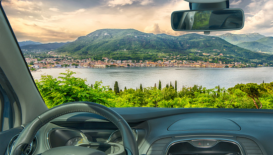 Looking through a car windshield with view of the town of Salo, on the Lake Garda, Italy