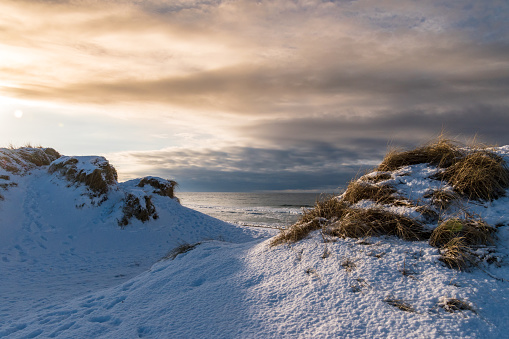 Dunes covered in snow sunset