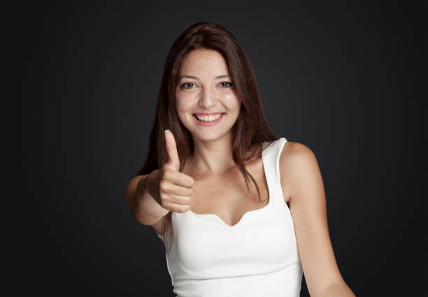 istock Smiling young girl giving a thumbs up 968505650