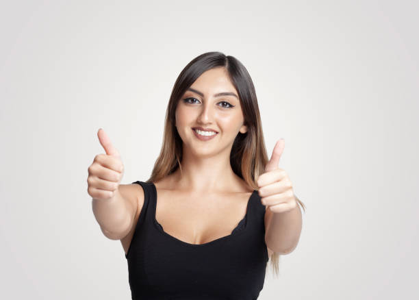 istock Smiling young girl giving a thumbs up 968509534