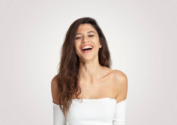 istock Beautiful young women laughing  while eyes closed 968512592