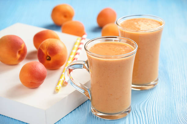istock Apricot smoothie, healthy beverage, on wooden background. 968521954
