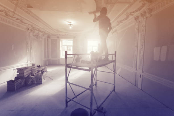 istock Workers  putty up ceiling walls in the room  in apartment is under construction, remodeling, renovation, extension, restoration and reconstruction. Image with tone and gradient effects 968526692