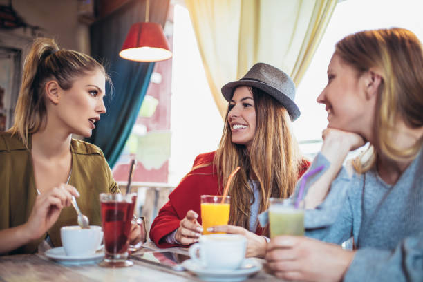 istock Friends enjoying in conversation and drinking coffee. 968530228
