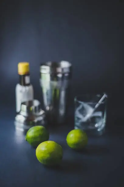 A still life of cocktail ingredients on a black background.