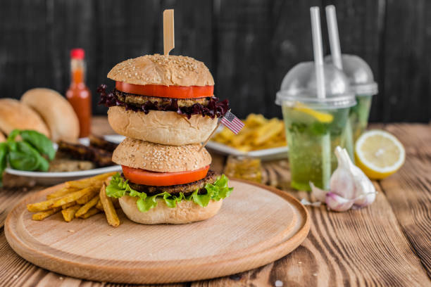 istock Tasty hamburger with meat and vegetables against a dark background 968536924