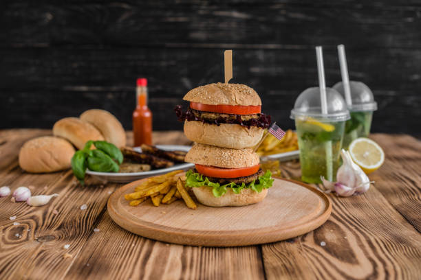 istock Tasty hamburger with meat and vegetables against a dark background 968536930