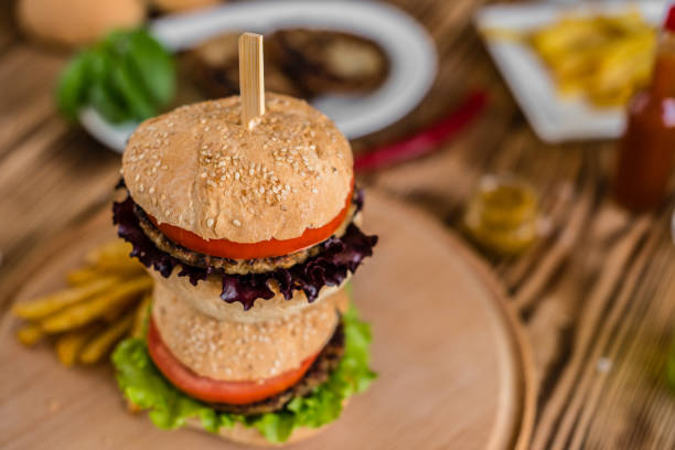 istock Tasty hamburger with meat and vegetables against a dark background 968537012
