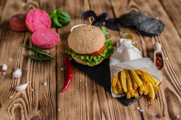istock Tasty hamburger with meat and vegetables against a dark background 968539152