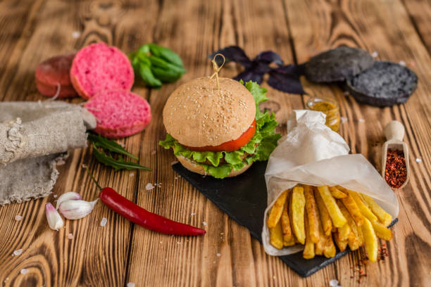 istock Tasty hamburger with meat and vegetables against a dark background 968539154