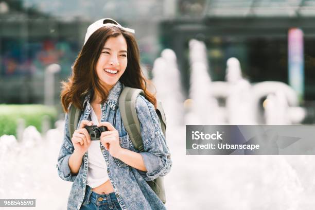Young Beautiful Asian Backpack Traveler Woman Using Digital Compact Camera And Smile Looking At Copy Space Journey Trip Lifestyle World Travel Explorer Or Asia Summer Tourism Concept Stock Photo - Download Image Now