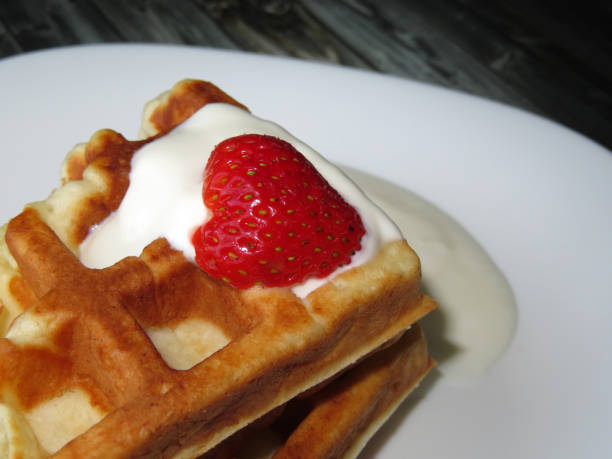 istock Belgian waffles with ripe strawberry and cream 968546034
