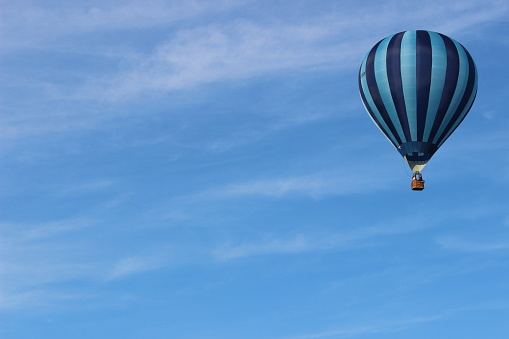 Blue striped hot air balloon in the clear blue sky