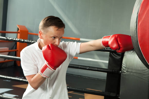 istock woman in the gym doing boxing 968571486