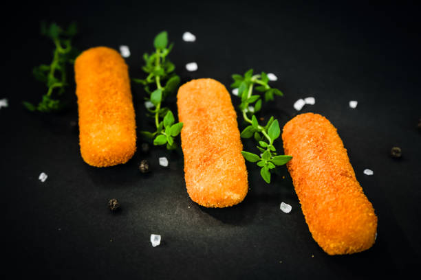 istock Fried fish sticks, fish fingers, served with thyme, salt and pepper 968588296