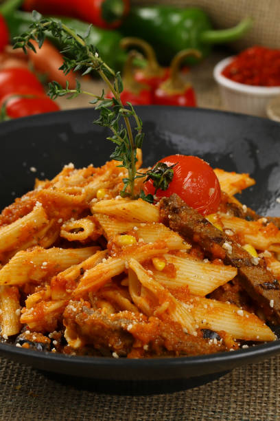 istock Penne pasta with beef meat and tomato sauce 968588356