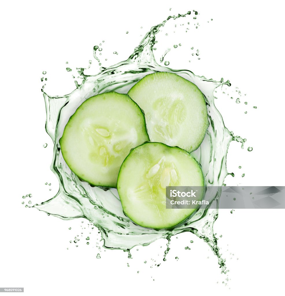 Cucumber slices rotate in splashes of juice on white background Cucumber Stock Photo