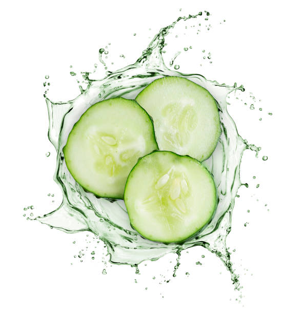 Cucumber slices rotate in splashes of juice on white background Cucumber slices rotate in splashes of juice on white background cucumber photos stock pictures, royalty-free photos & images
