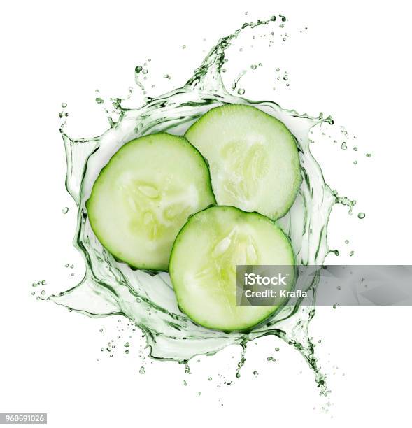 Cucumber Slices Rotate In Splashes Of Juice On White Background Stock Photo - Download Image Now