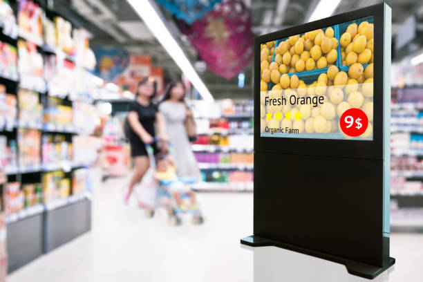 istock Intelligent Digital Signage , Augmented reality marketing and face recognition concept. Interactive artificial intelligence digital advertisement fresh orange organic farm in retail shopping Mall. 968593804