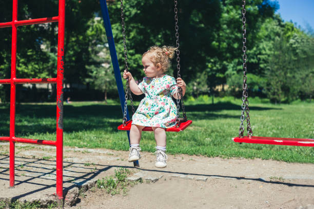 istock Little girl on swing 968594362