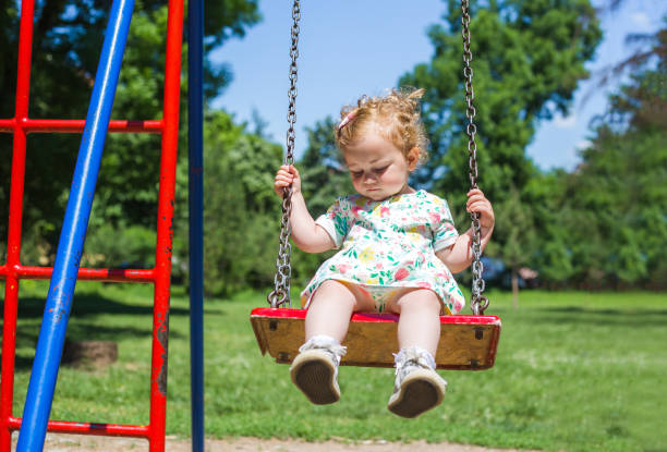 istock Little girl on swing 968596618