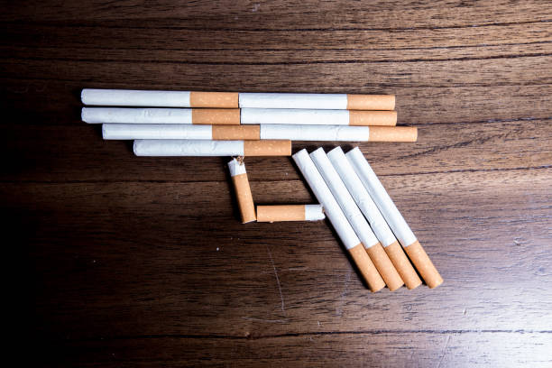 istock Concept of handgun with cigarettes as bullets 968597064