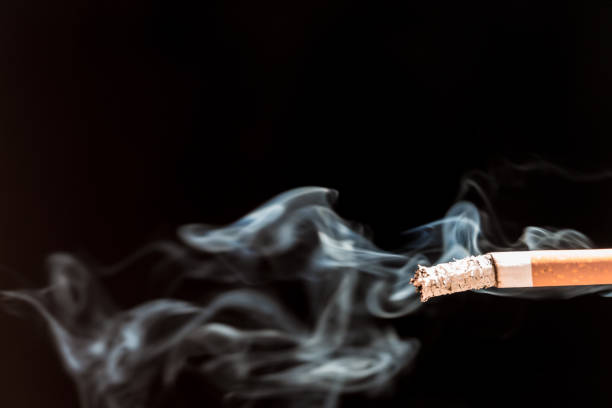 istock Burning cigarette with smoke and concept of cigarettes 968599896