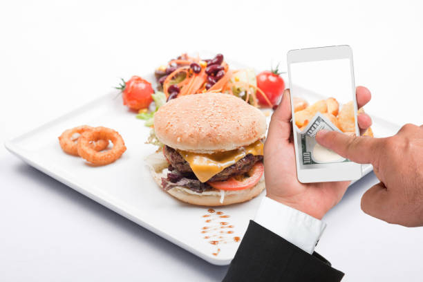 istock Hamburger and businessman using smartphone with online payment 968602558