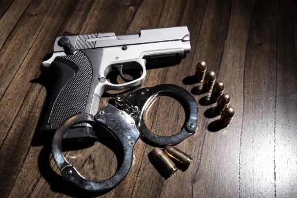 istock Gun handcuff and bullets as a concept for a sting 968602876