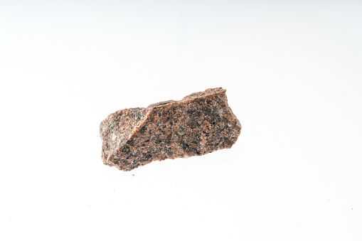 syenite mineral sample studio shot with white background