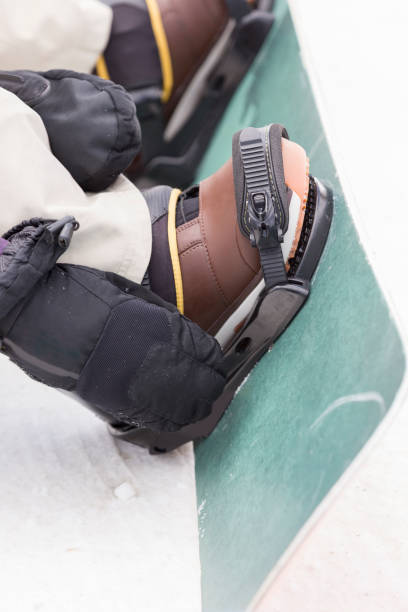 closeup of woman's feet on snowboard - snowboard boot imagens e fotografias de stock