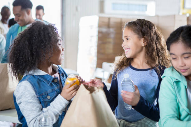 istock Elementary age friends volunteering in food bank 968605902