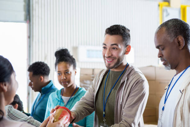 istock Young man volunteering in food bank 968605904