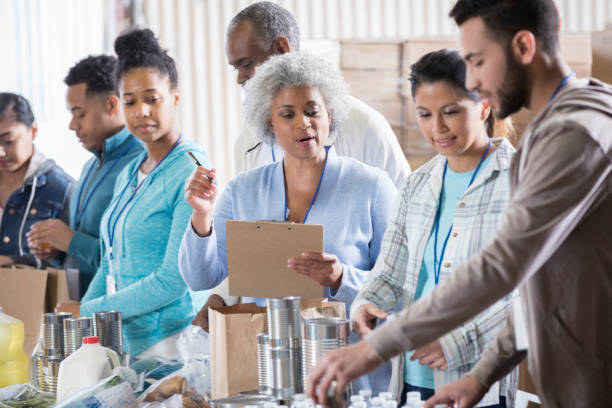 istock Food bank manager instructs volunteers 968605920