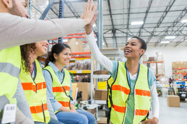 istock Warehouse employee receives congratulations during team meeting 968606052