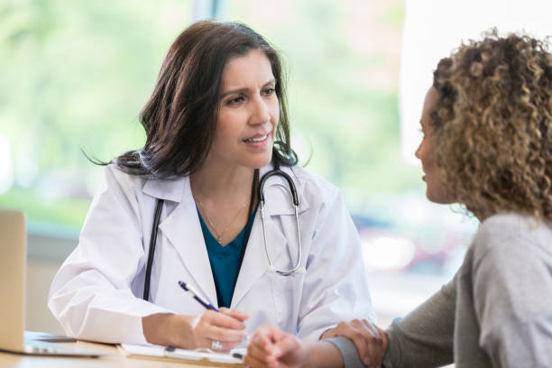 istock Doctor comforts young female patient 968608466
