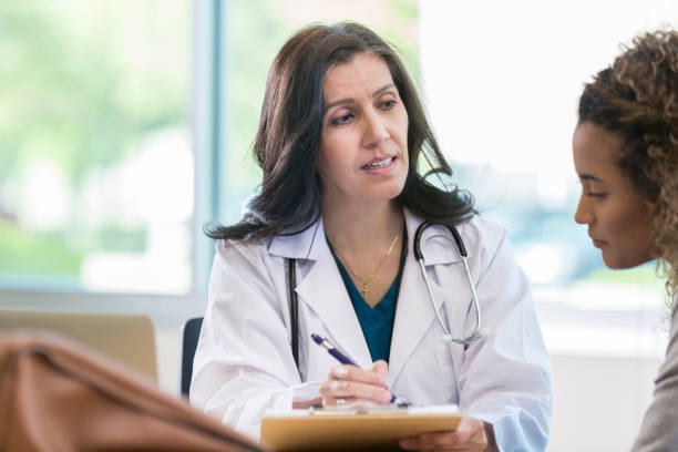 istock Mature doctor talks with female patient 968608468
